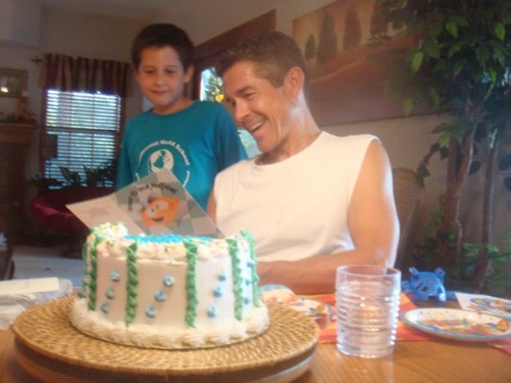 Son looking over Dad's shoulder as he reads his birthday card