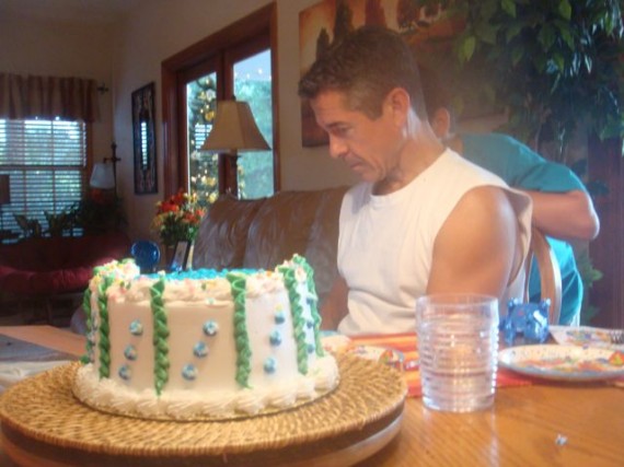 Son looking over Dad's shoulder as he reads his birthday card