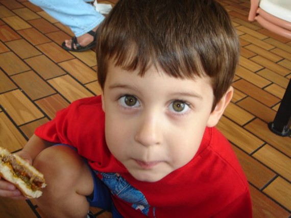Young, hopeful boy staring at camera