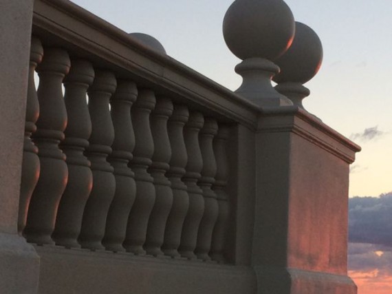 The very fist golden rays of the sun barley touching the railing pillars