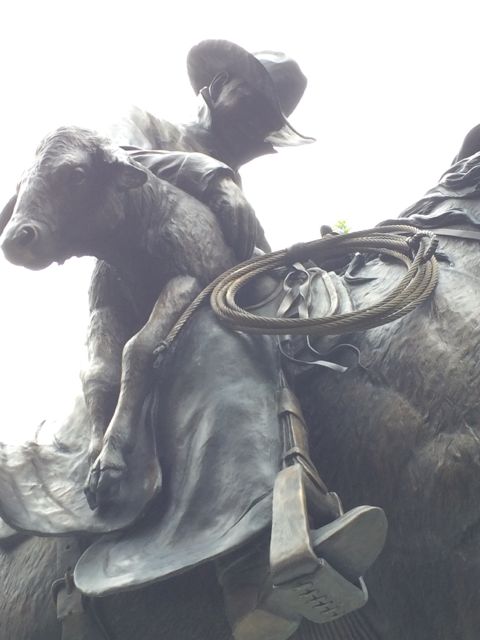 Bronze statue of horseman saving calf at CSU campus