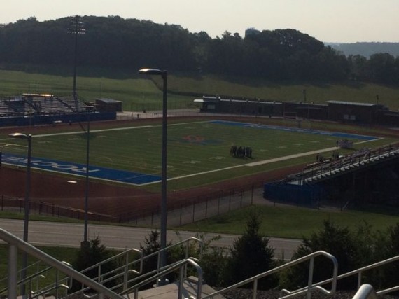High School soccer team huddled on field