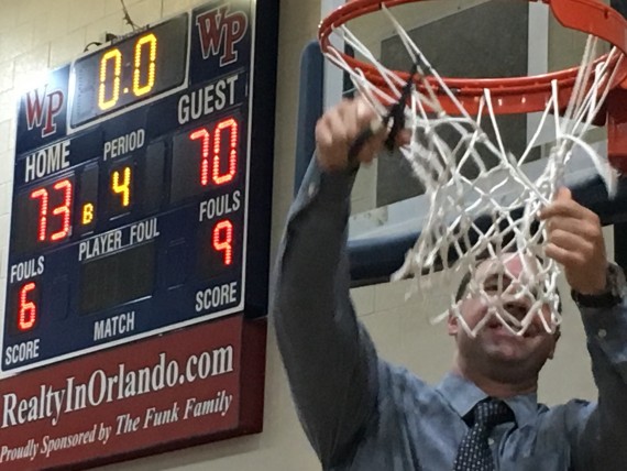 Cutting down the basketball net after winning