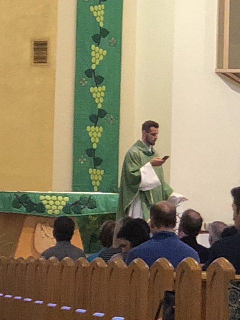 Catholic Priest using iPhone