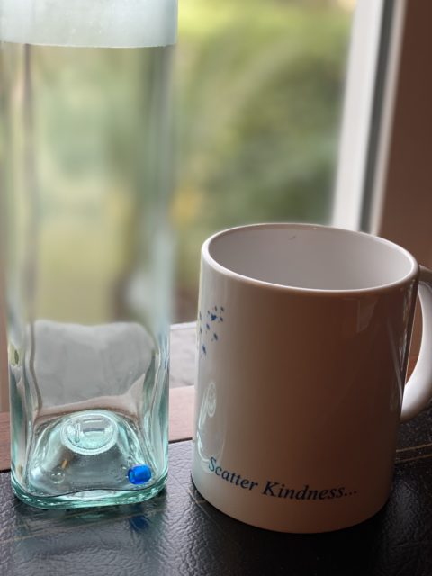 empty glass jar and coffee mug on desk