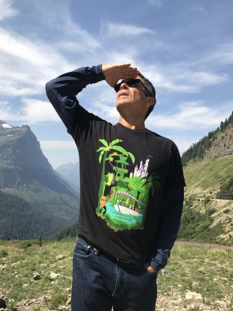 man staring at sky, hand held above eyes