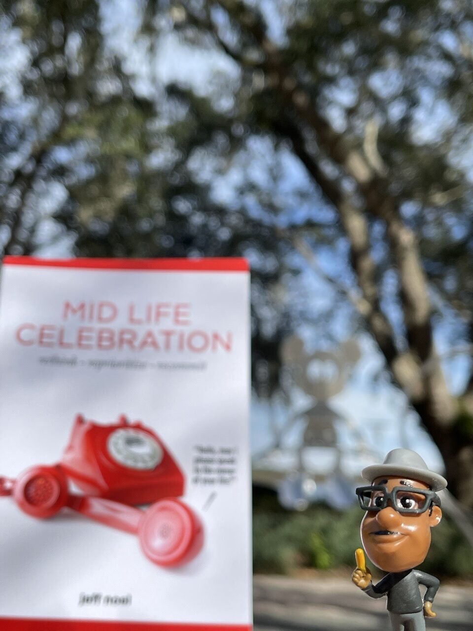 The book Mid Life Celebration with a couple of Pixar soul small toy characters