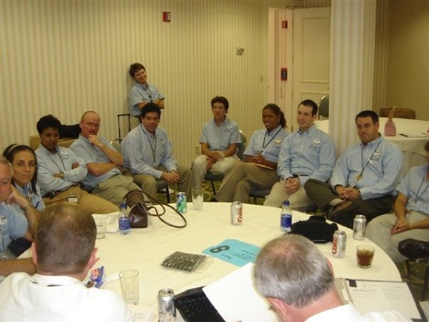 Team of 14 gathered around a table