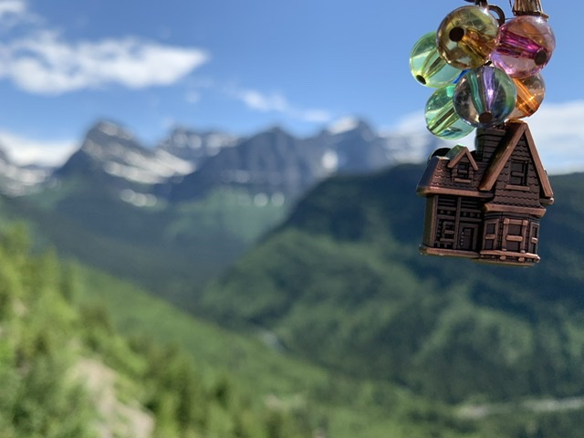 small toy trinket house with mountains in background