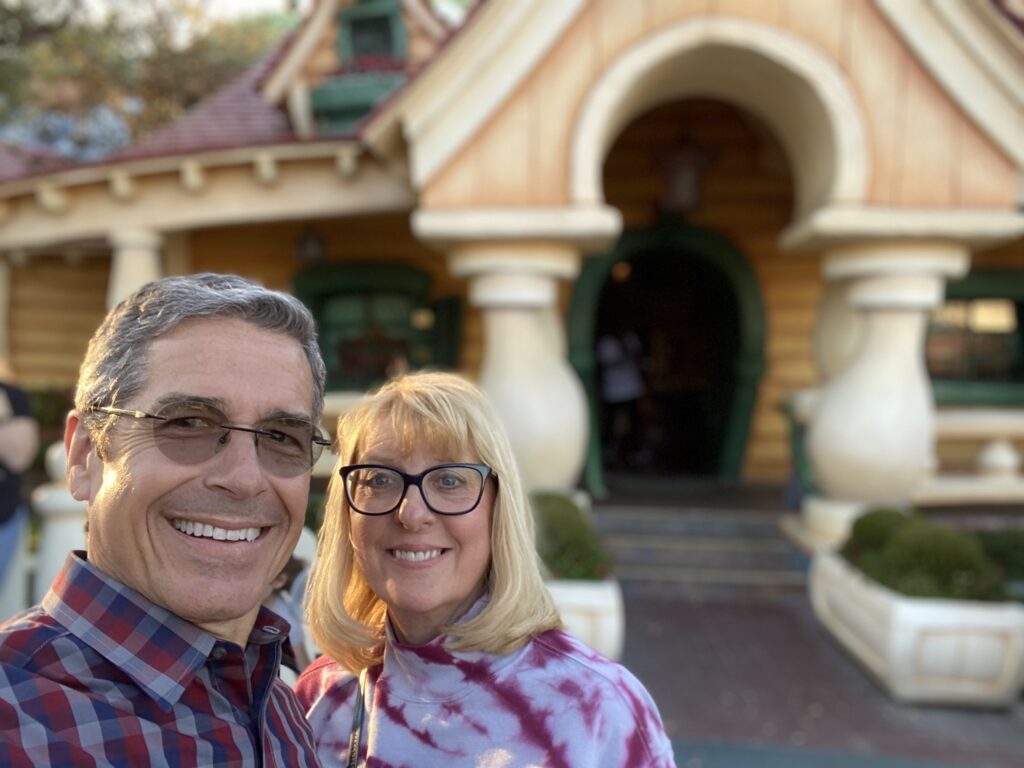 Married couple in front of Mickey Mouse's House