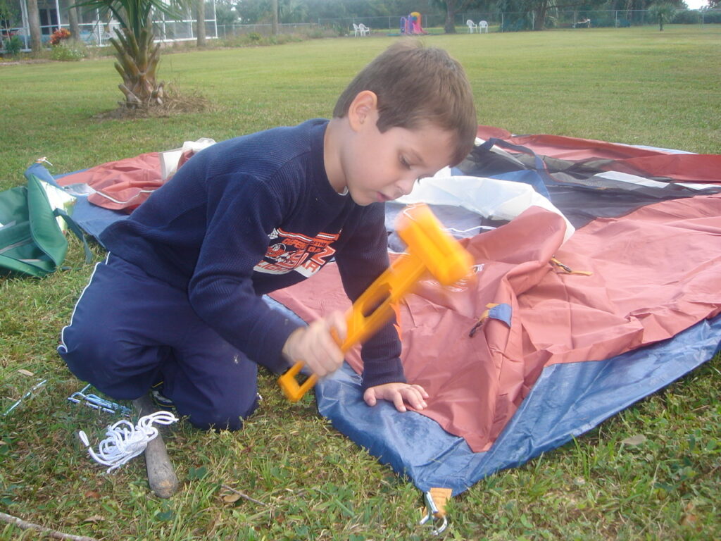 boy using plastic hammer
