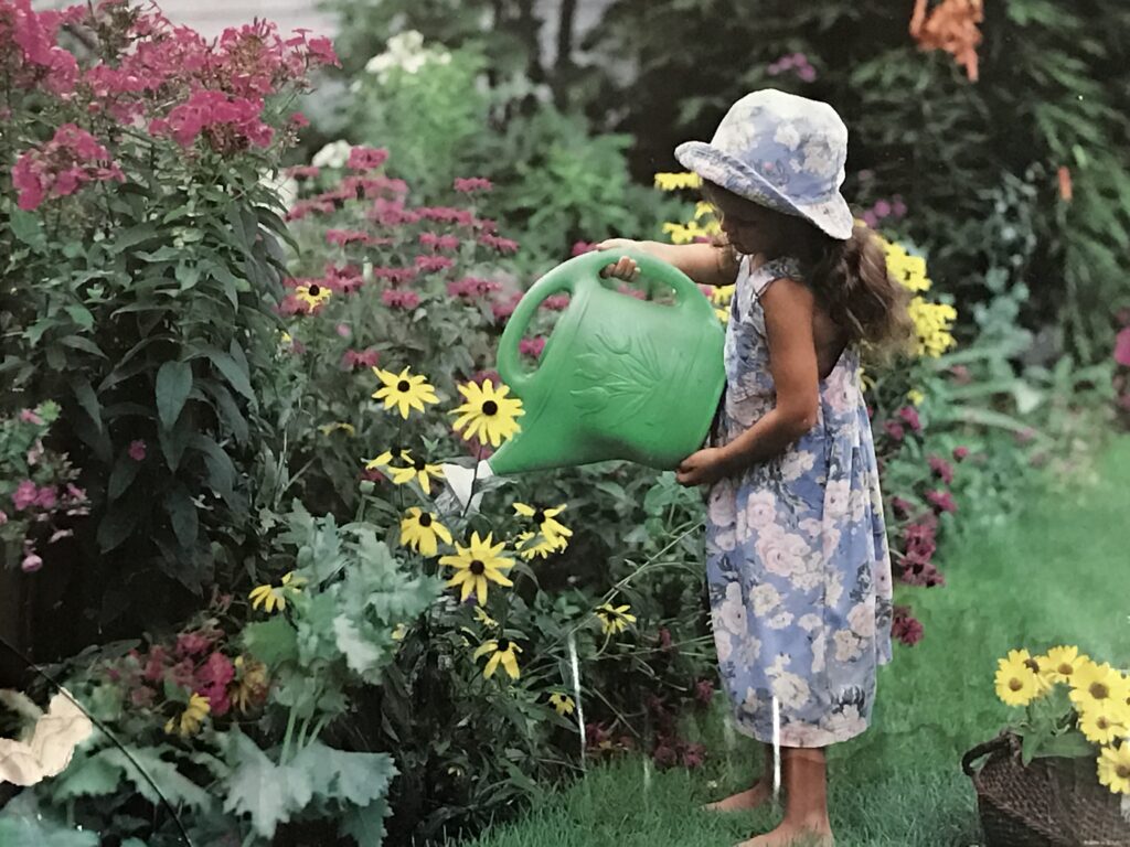 child watering flowers