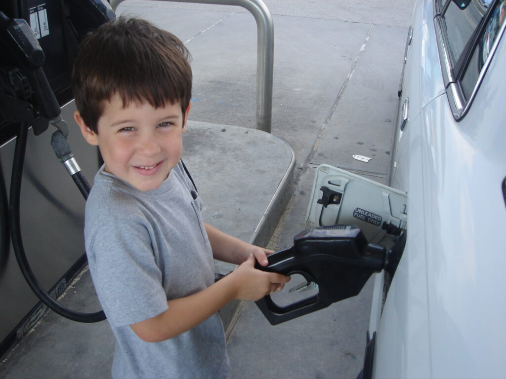 child pumping gas
