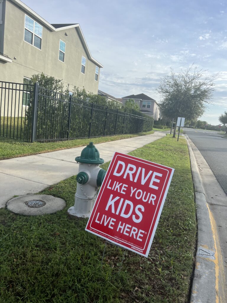 Drive like your kids live here sign
