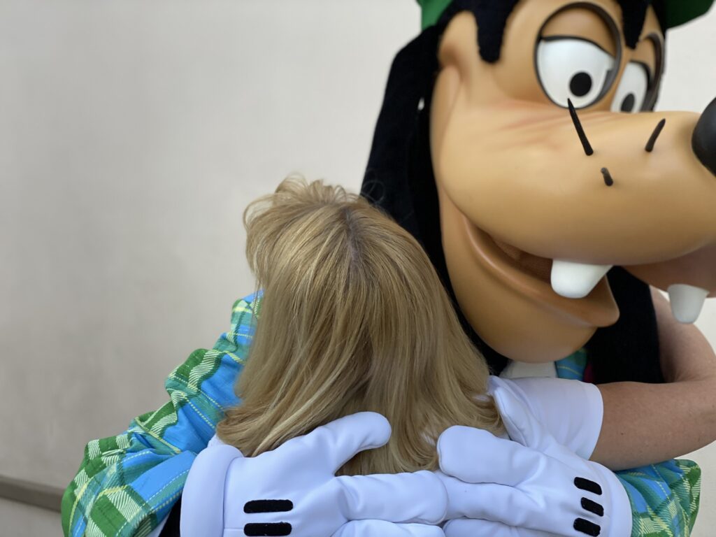 Goofy hugging a woman