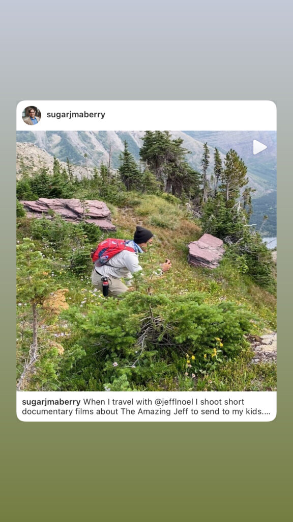 man taking pictures in the mountains