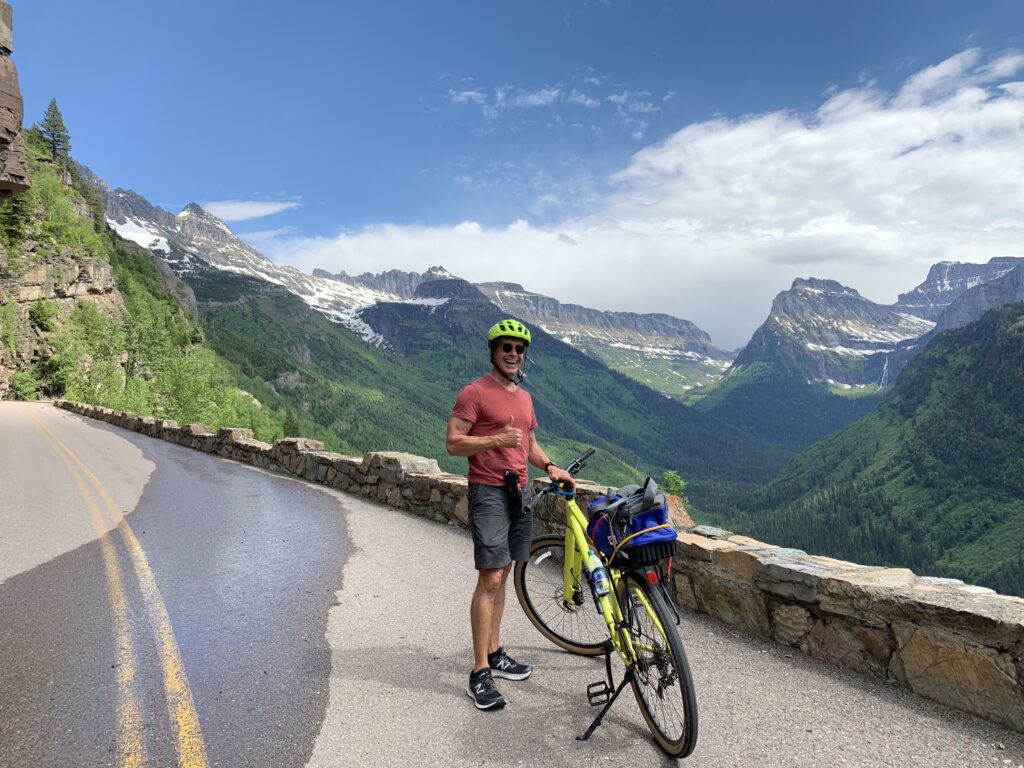 Disney speaker Jeff Noel biking up a mountain