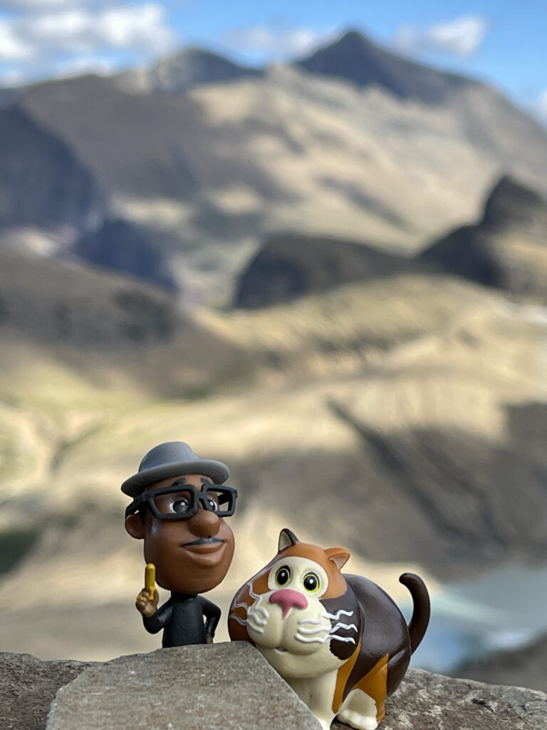 Small Pixar toy characters in mountains