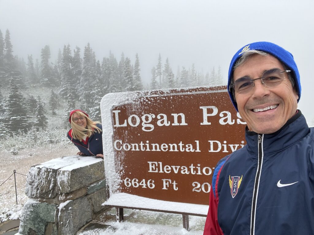 Couple at national park sign in snow